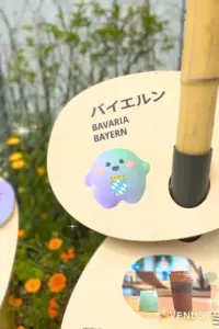 大阪万博2025｜ドイツ館キャラクター・バイエルンVer. のサーキュラーちゃん（チェックデザインがほっこりかわいい）